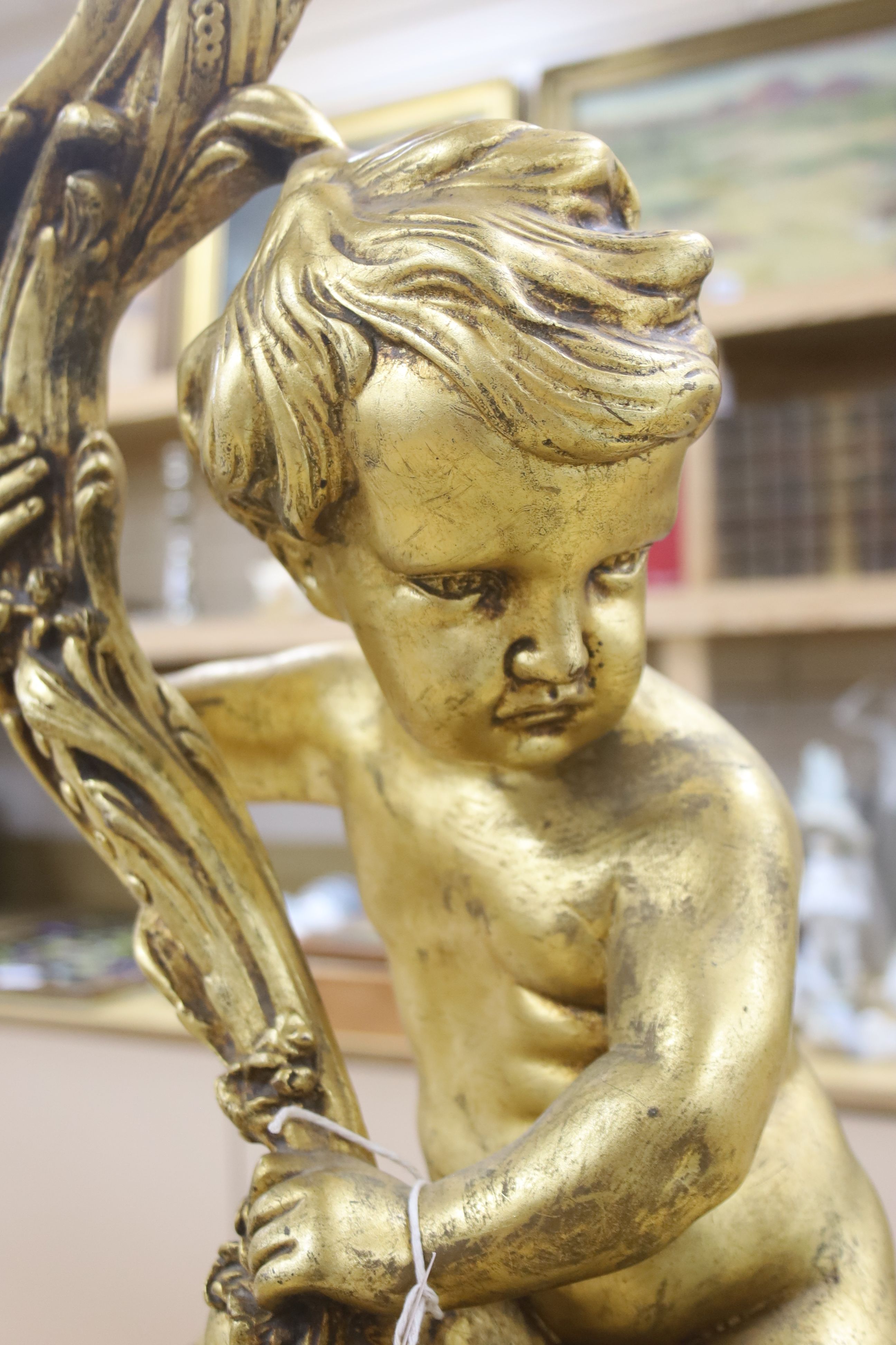 A large moulded gilt putti table lamp, height 70cm excl. light fitting